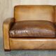 Three-seater Art Deco style leather sofa with feather cushions.