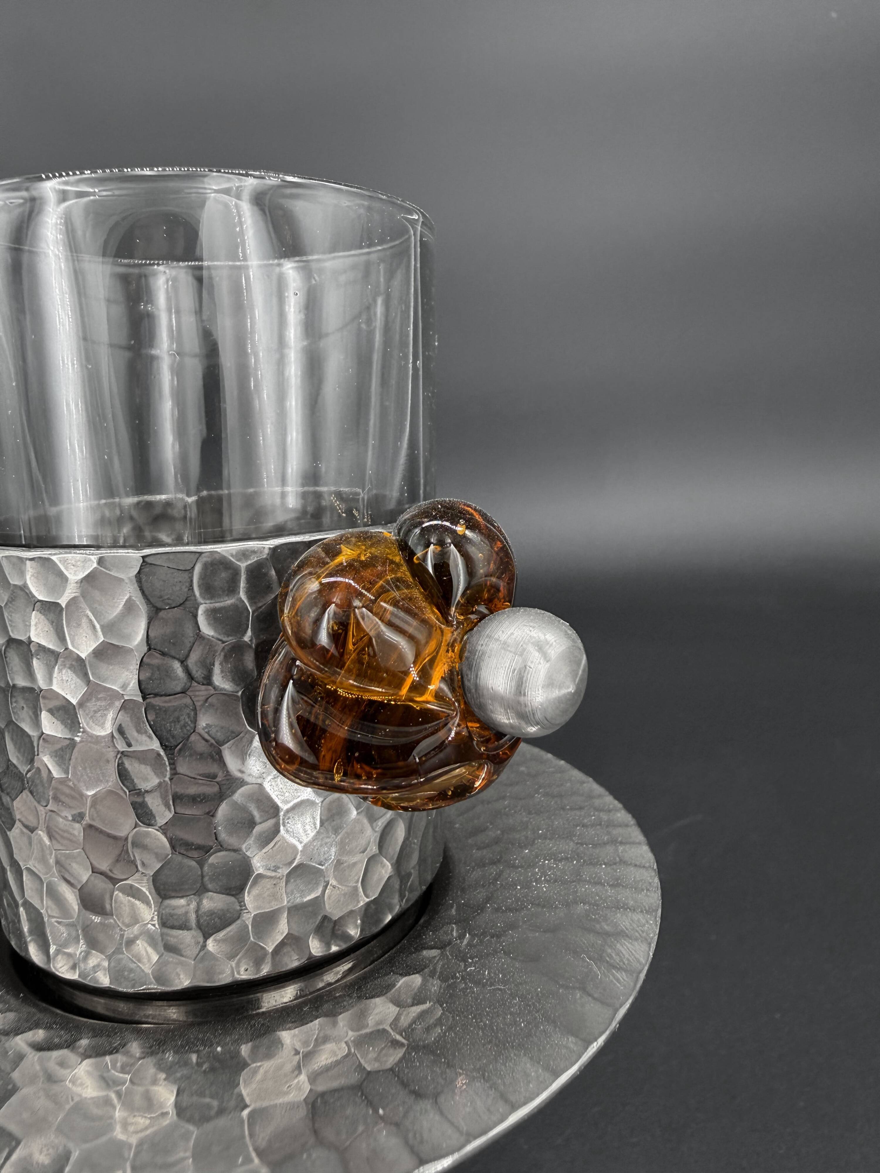 Duo of hammered metal and blown glass cups — handcrafted work