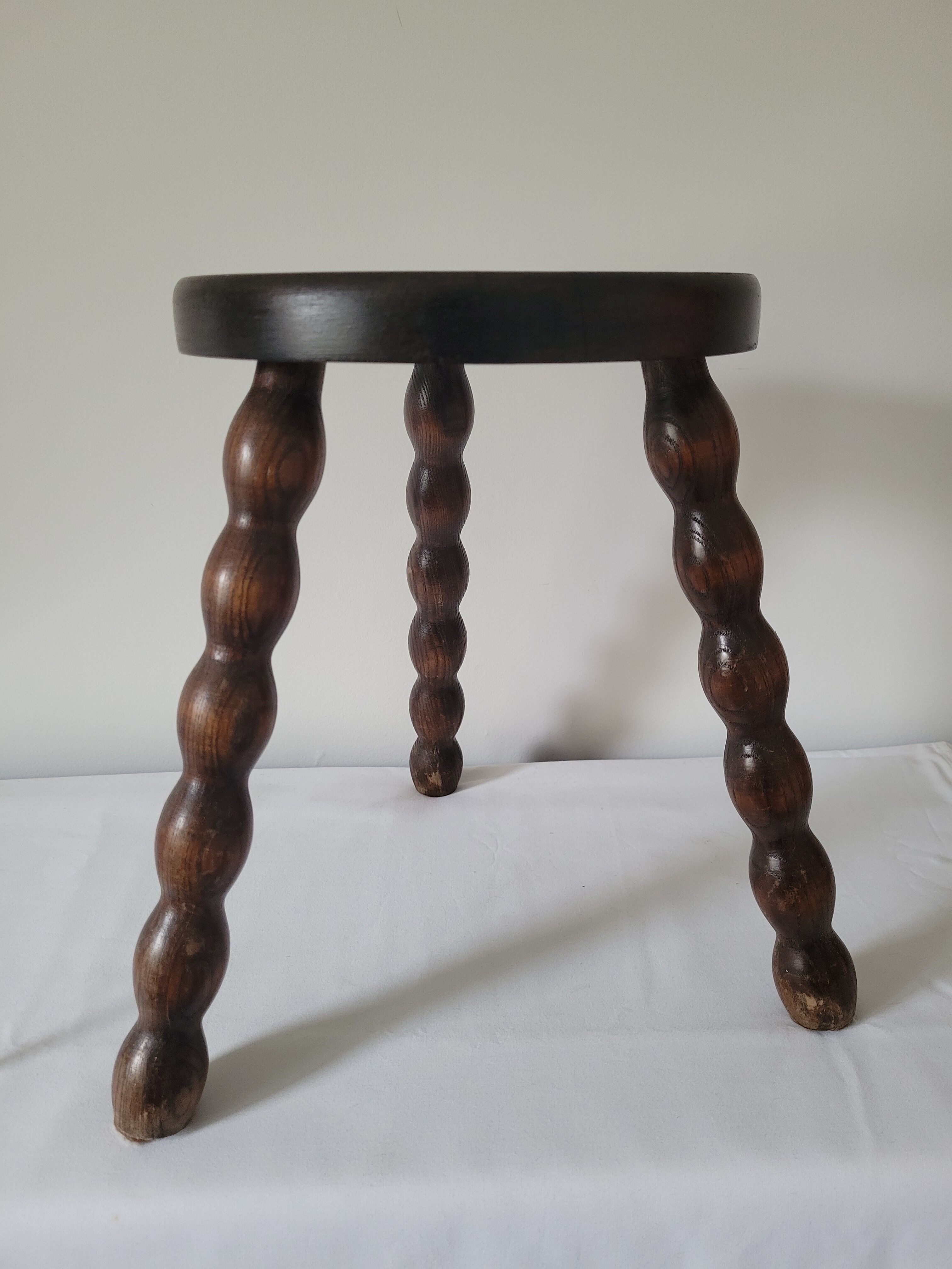 Brutalist stool with turned wooden legs