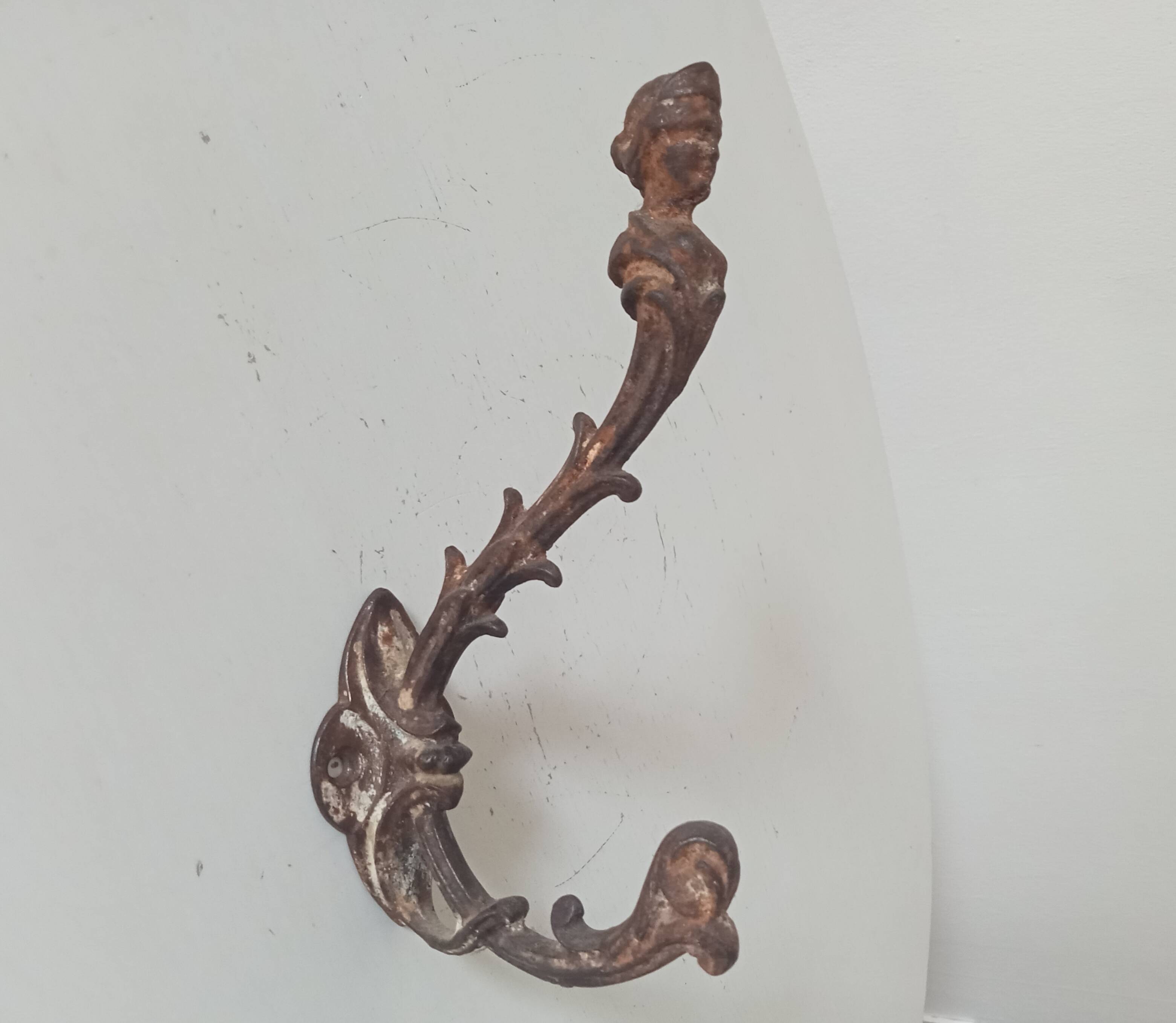 Antique wall coat hook from the 19th century in Victorian cast iron style.
