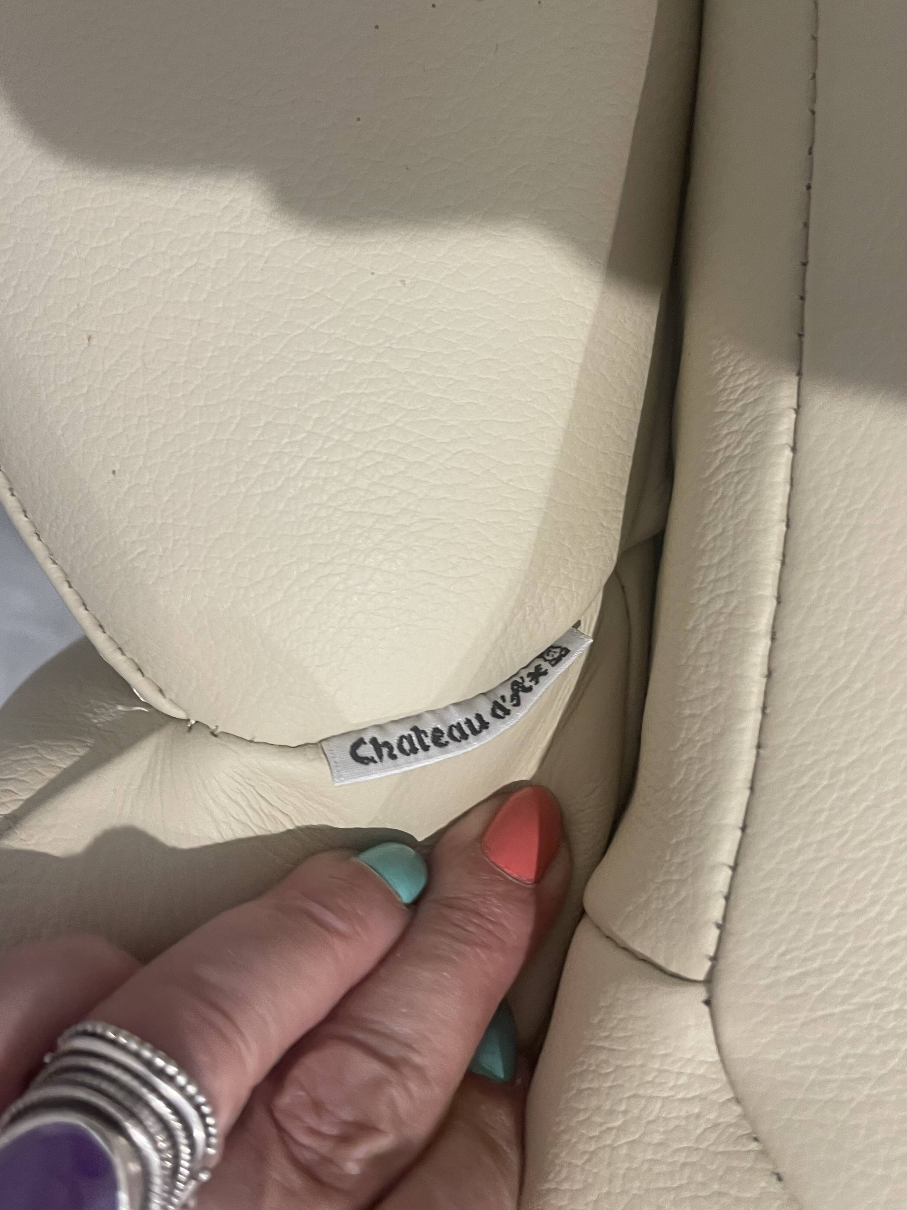 Pair of vintage leather armchairs with ottoman