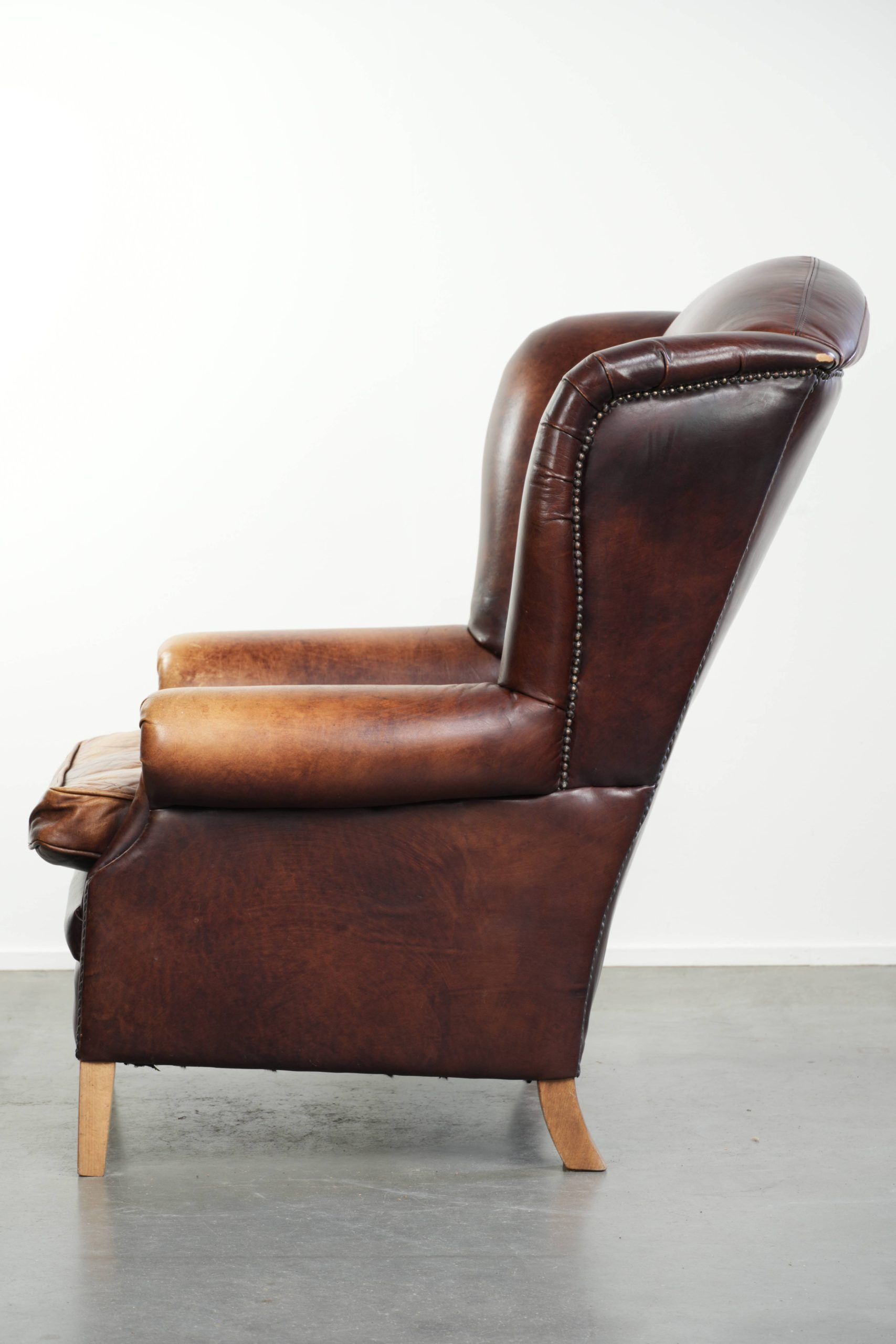 Comfortable cowhide wingback armchair in English style