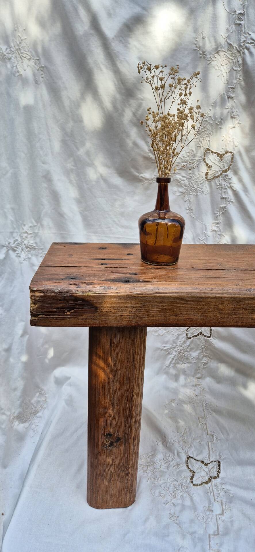 Brutalist wooden bench made of solid oak beam.