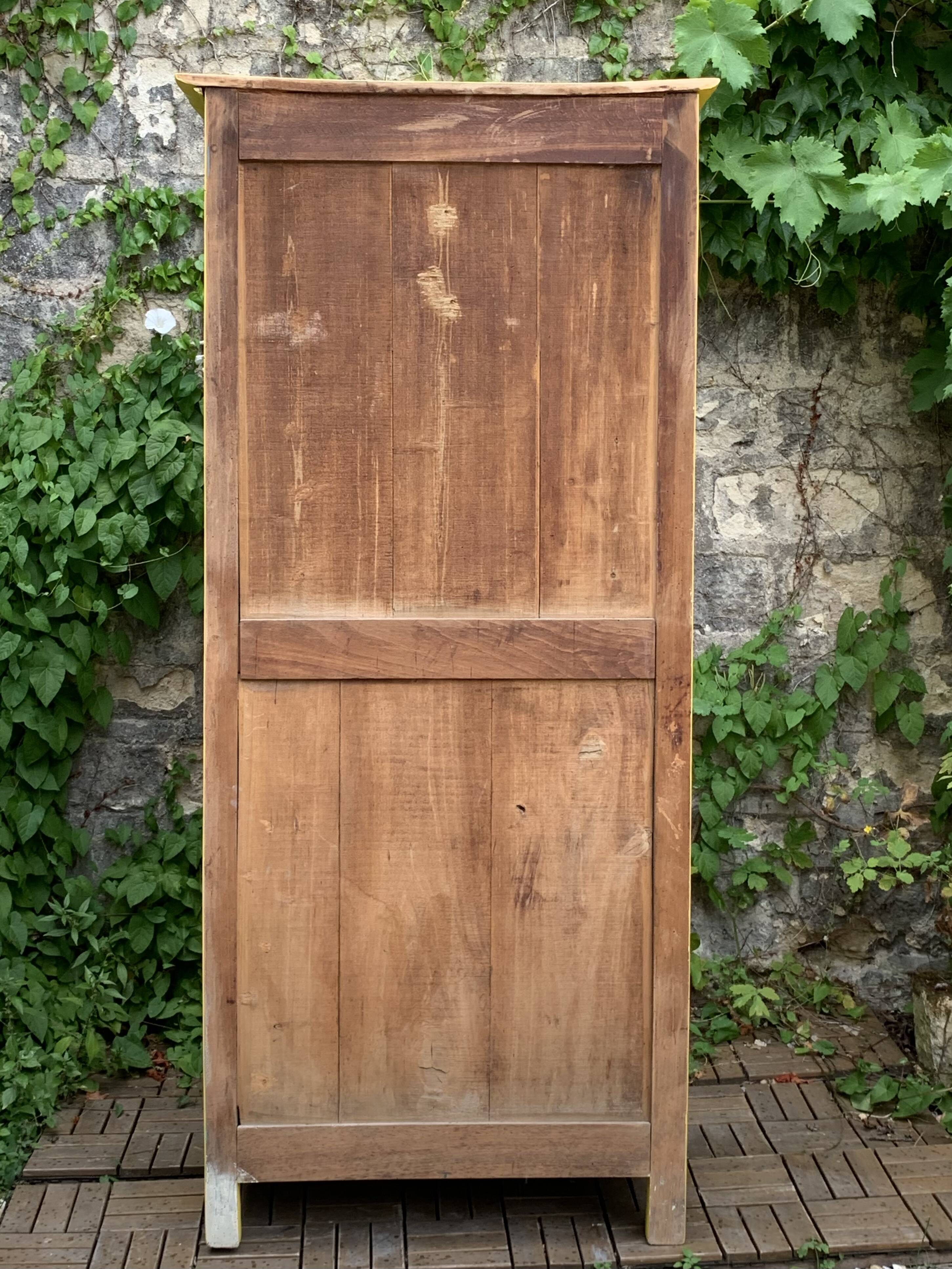 Antique powder yellow Parisian bonnetière wardrobe.