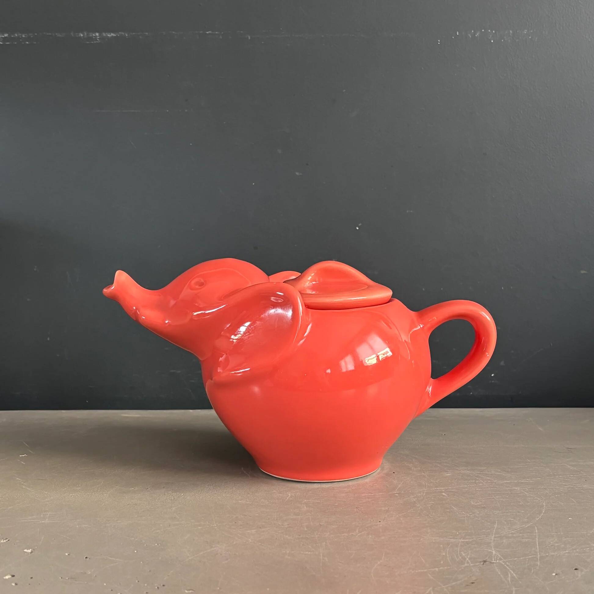 Large coral-coloured elephant teapot.