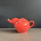 Large coral-coloured elephant teapot.