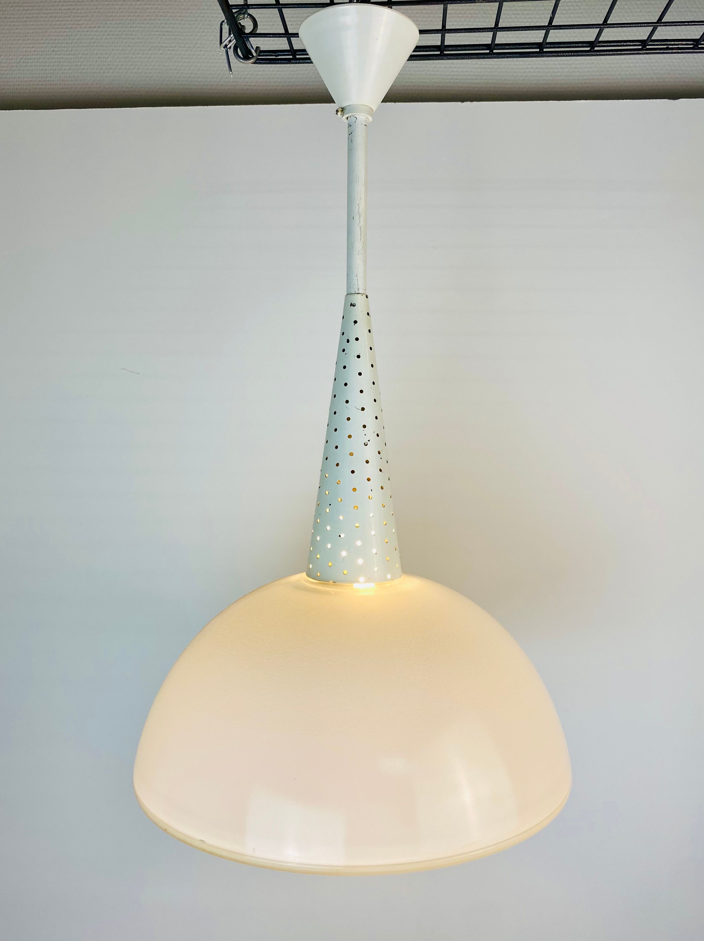 Perforated metal suspension holophanous glass