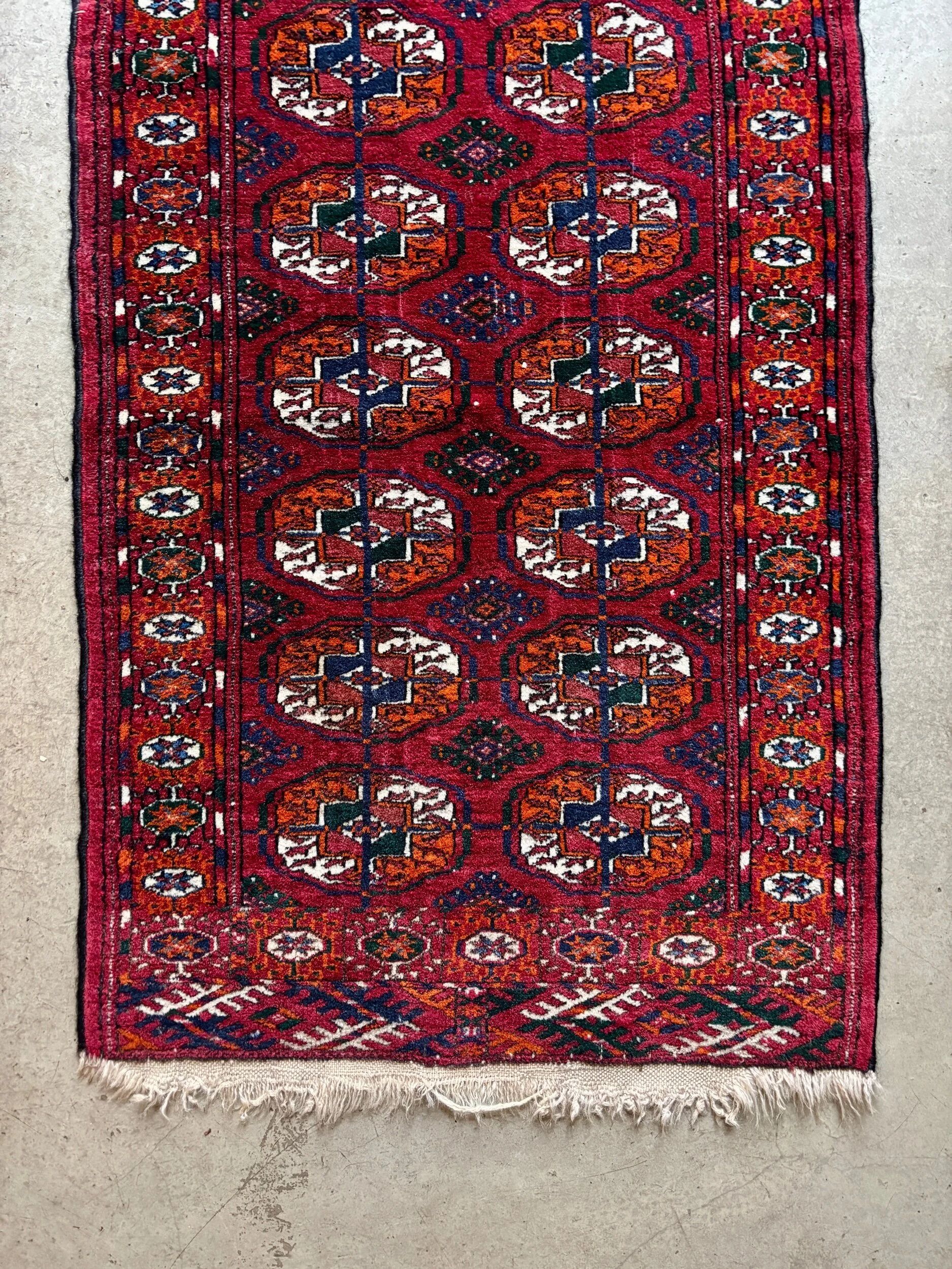 Bukhara rug with 12 panels in wool and burgundy silk, 88 x 54 cm.