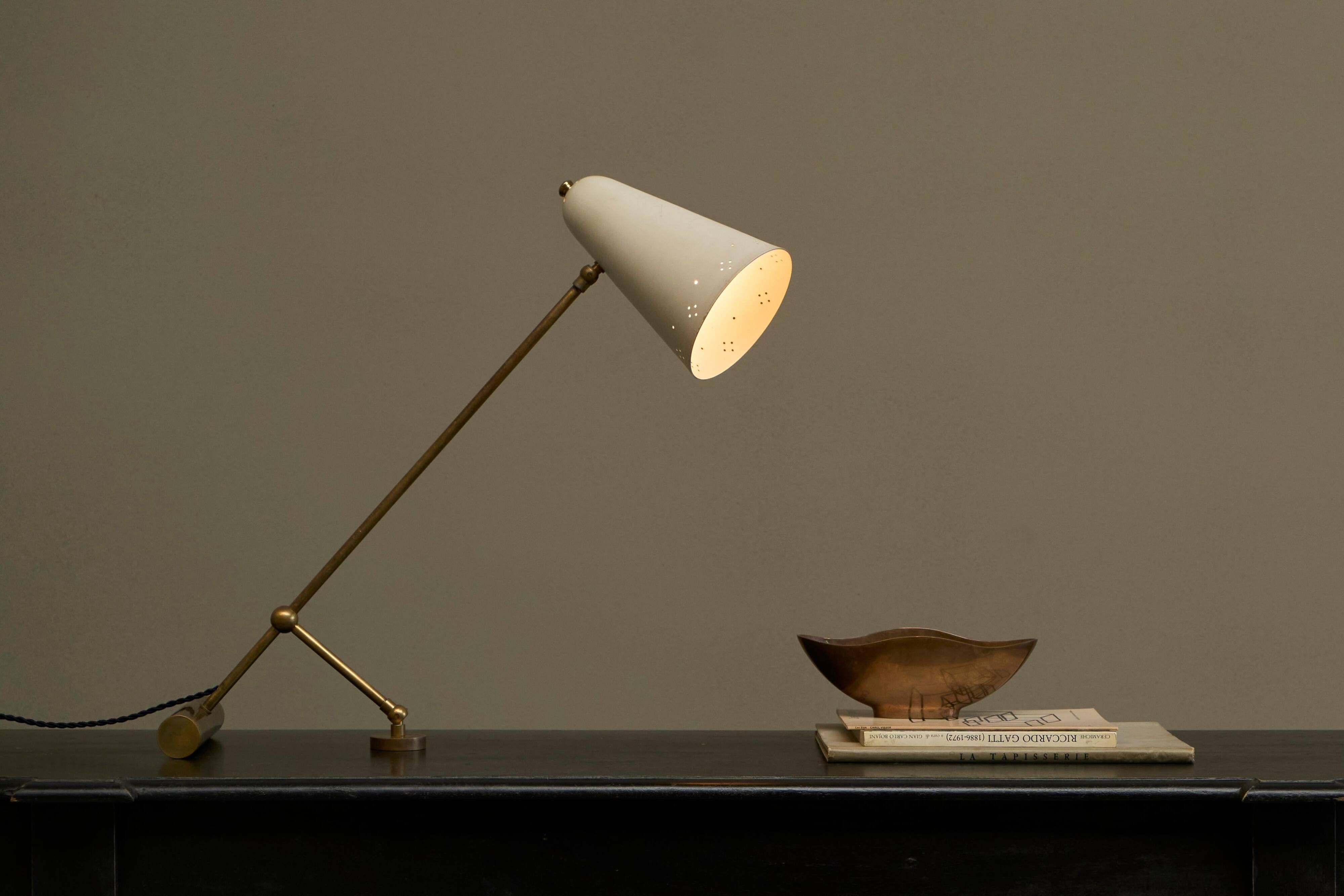 Mid Century adjustable table lamp with perforated shade from the 1950s.