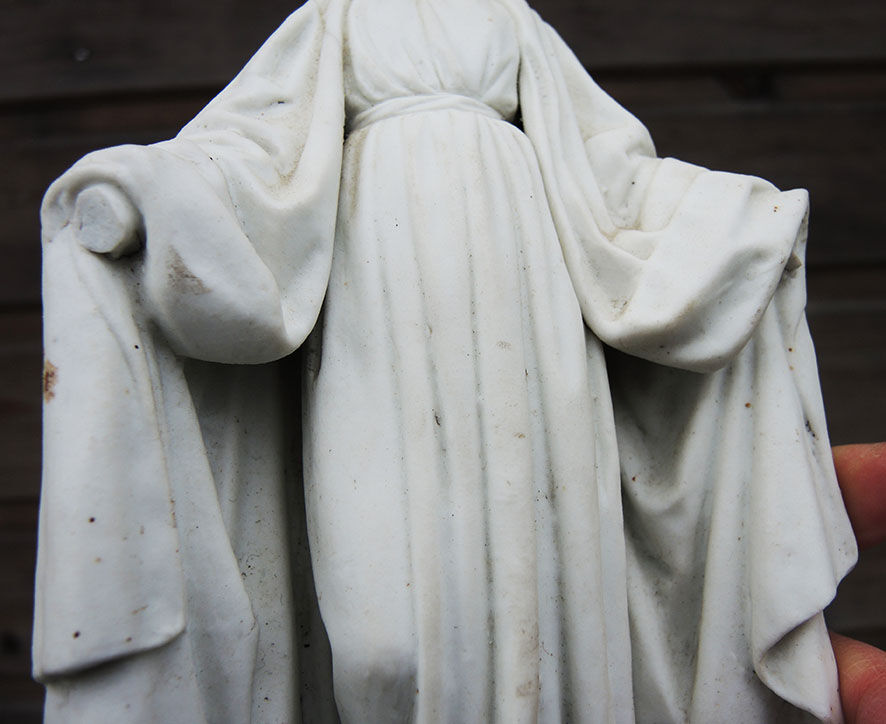 Ancient statuette of the virgin with the serpent in biscuit