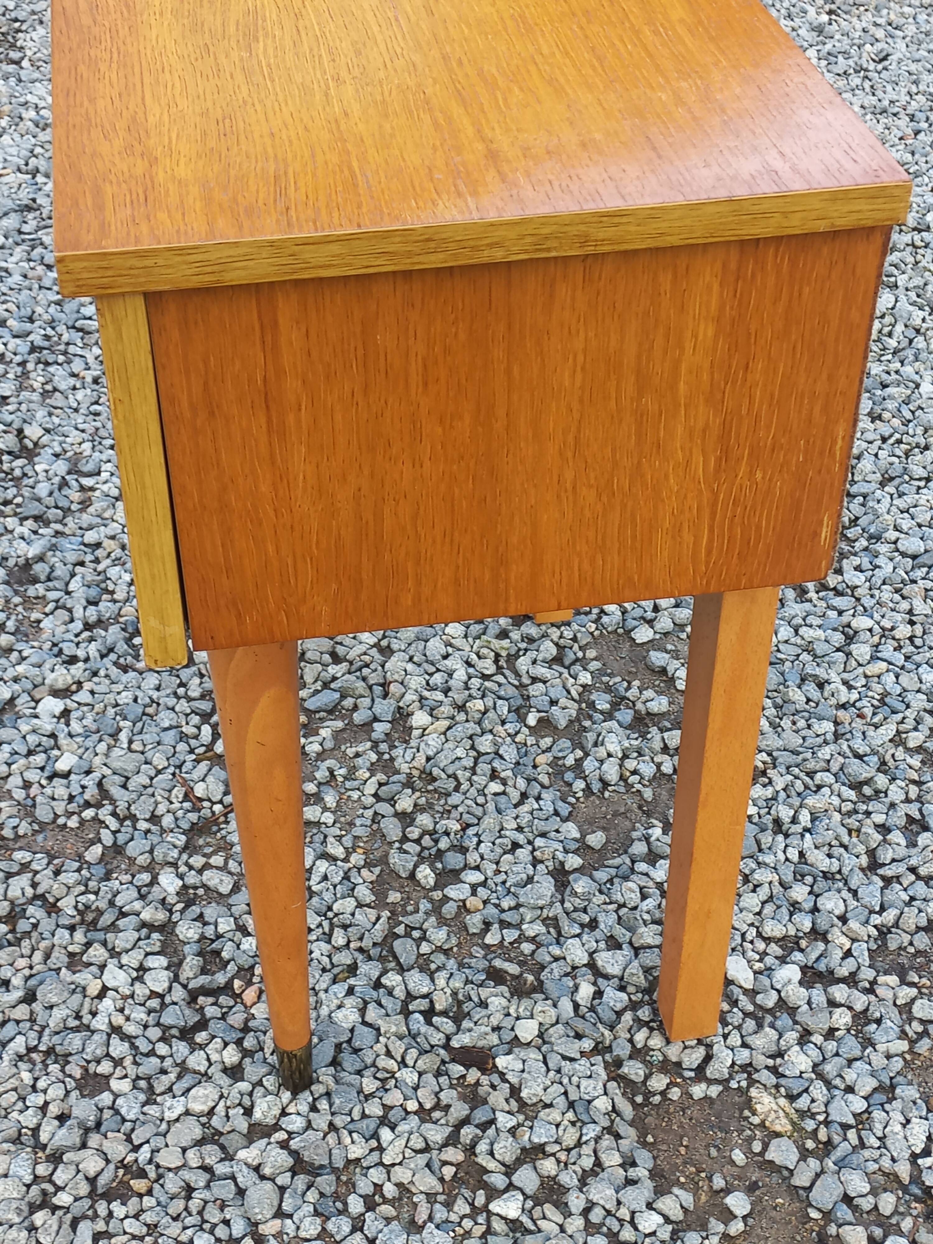 Vintage 1950s bedside table in blond oak with conical legs