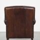 Dark brown sheepskin armchair finished with decorative nails