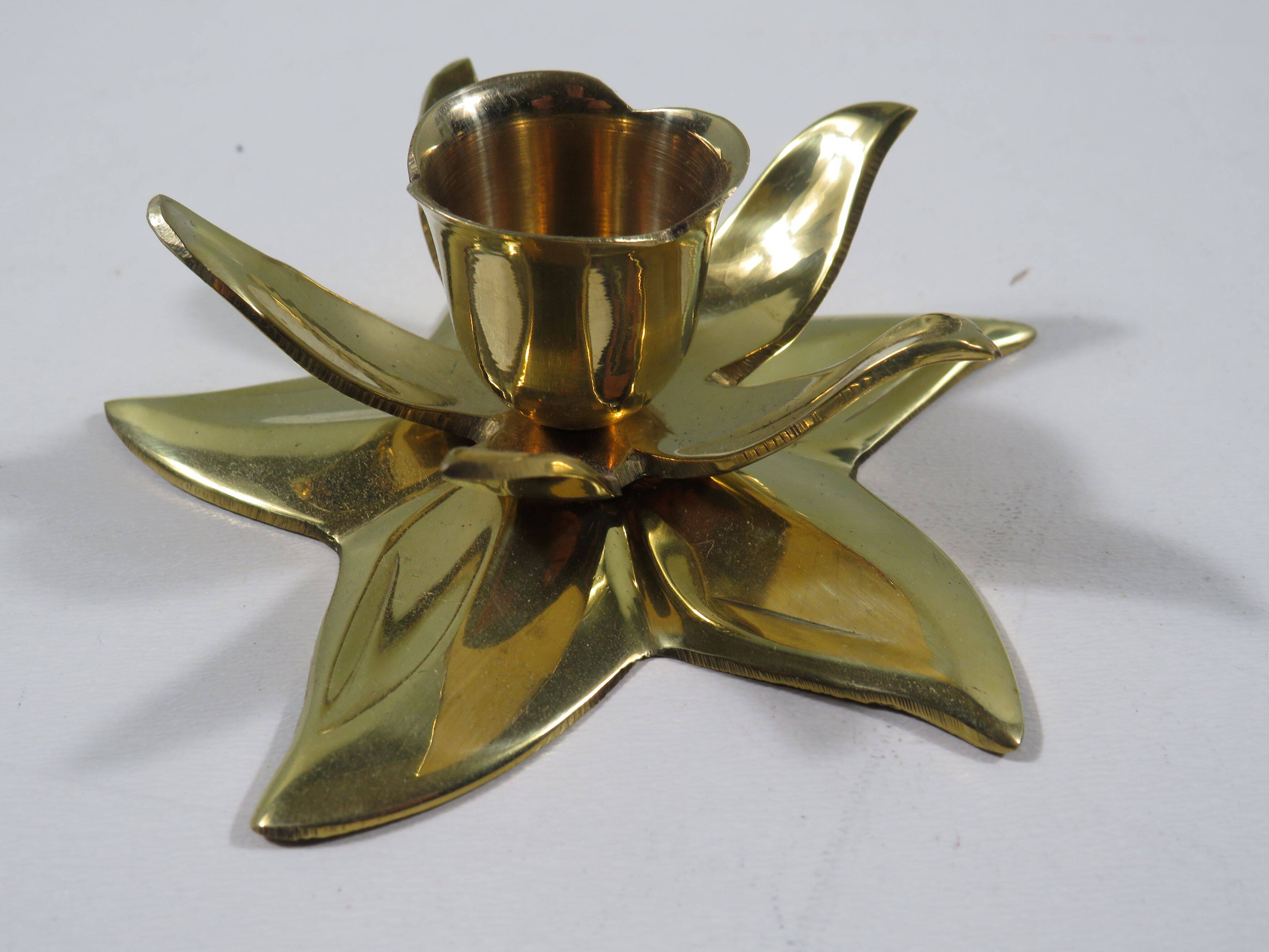 Set of 7 heavy shiny brass flower shaped candle holders, 1970-1980