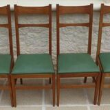 6 modern chairs with banded backs and green faux leather seats