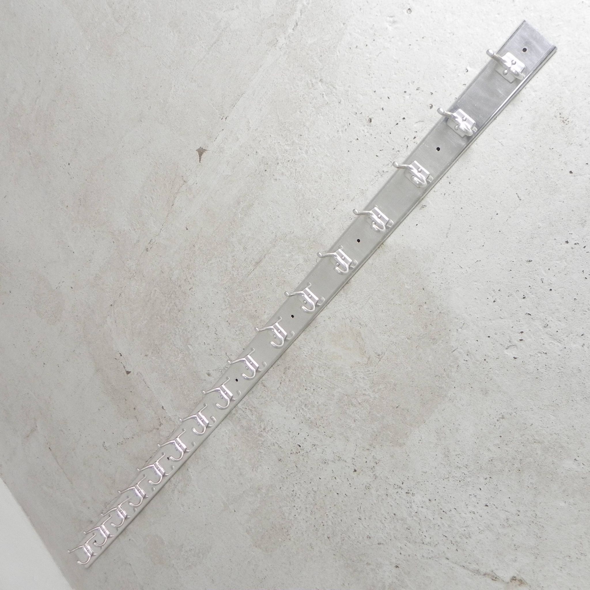 Wall-mounted aluminium coat rack of 225 cm with 16 double hooks, 1960s.
