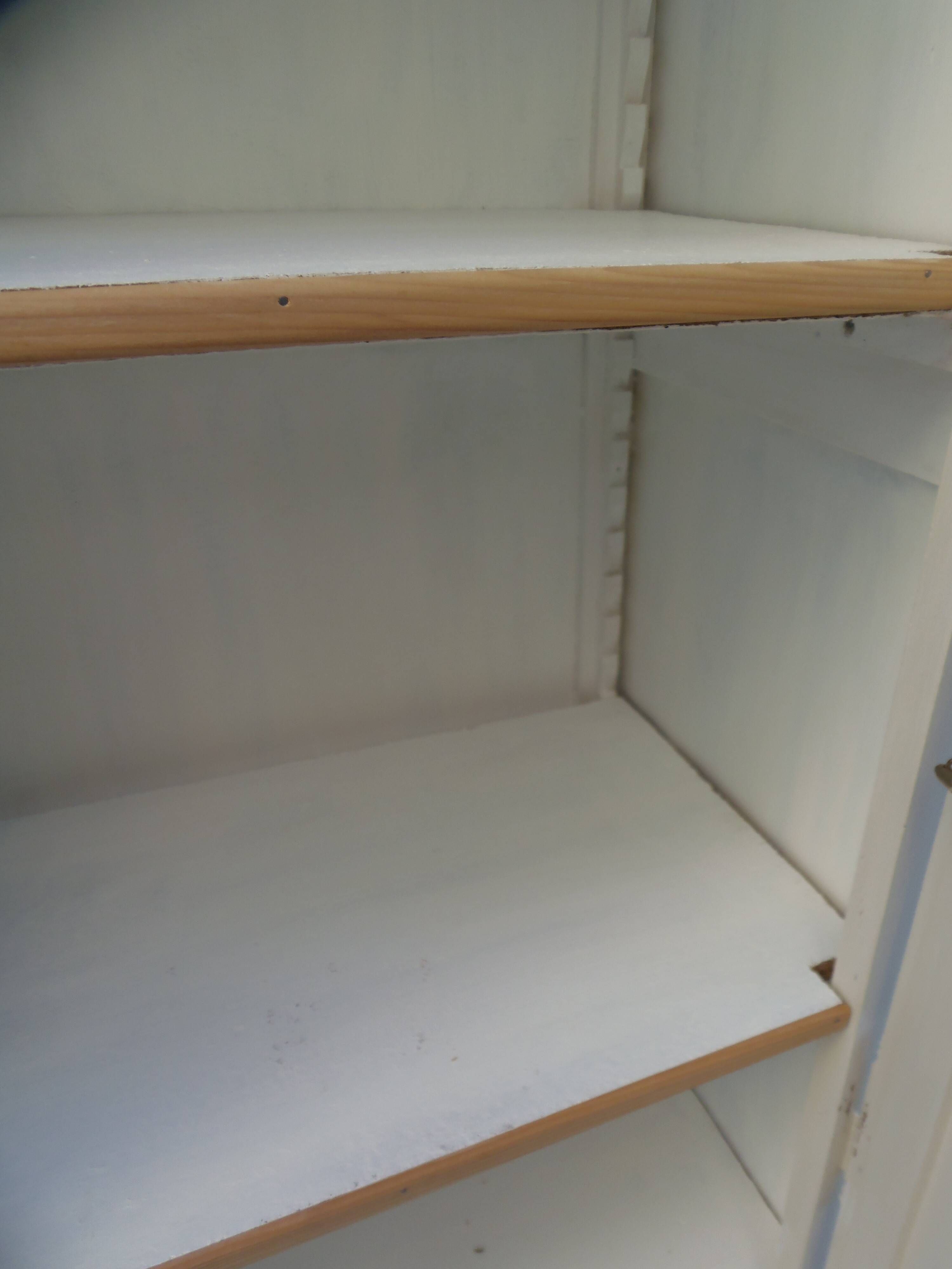 Vintage beige wardrobe made of wood and jute fabric.