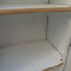Vintage beige wardrobe made of wood and jute fabric.