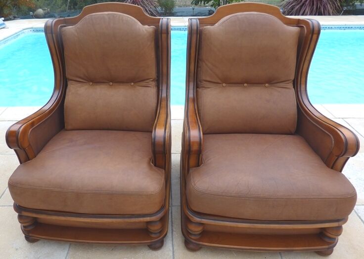 Pair of aged leather armchairs with seat and firm backrest with cherry wood frame