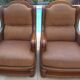 Pair of aged leather armchairs with seat and firm backrest with cherry wood frame