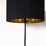 Black metal magazine rack floor lamp with ceramic shelf