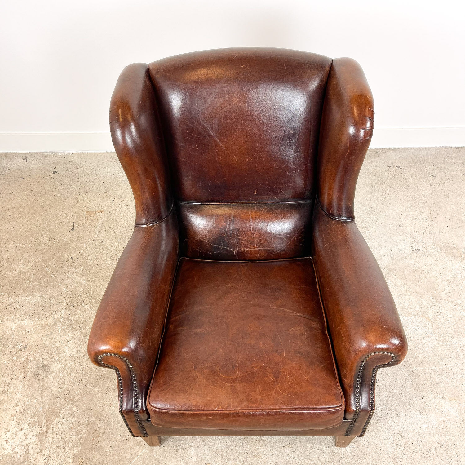 Vintage dark brown sheep leather wingback armchair
