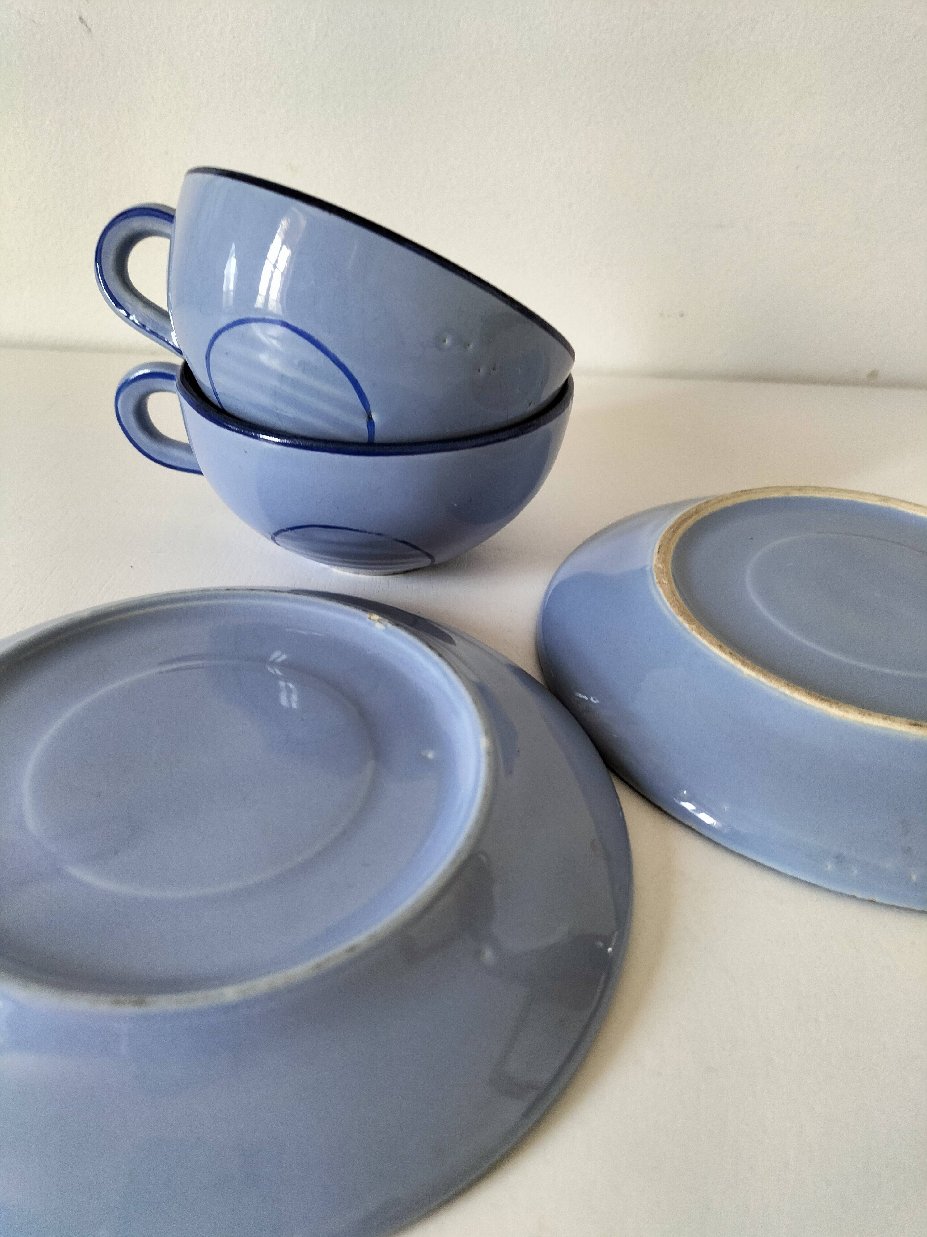 A pair of glazed ceramic cups and saucers from the 60s-70s.