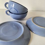 A pair of glazed ceramic cups and saucers from the 60s-70s.