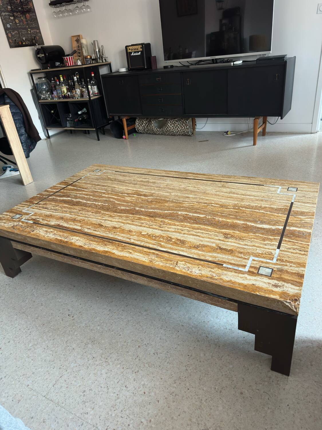 Coffee table in travertine with mother-of-pearl inlays.