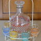 Service a Liqueur consisting of a metal servant, a carafe and 6 small vintage glasses 1950