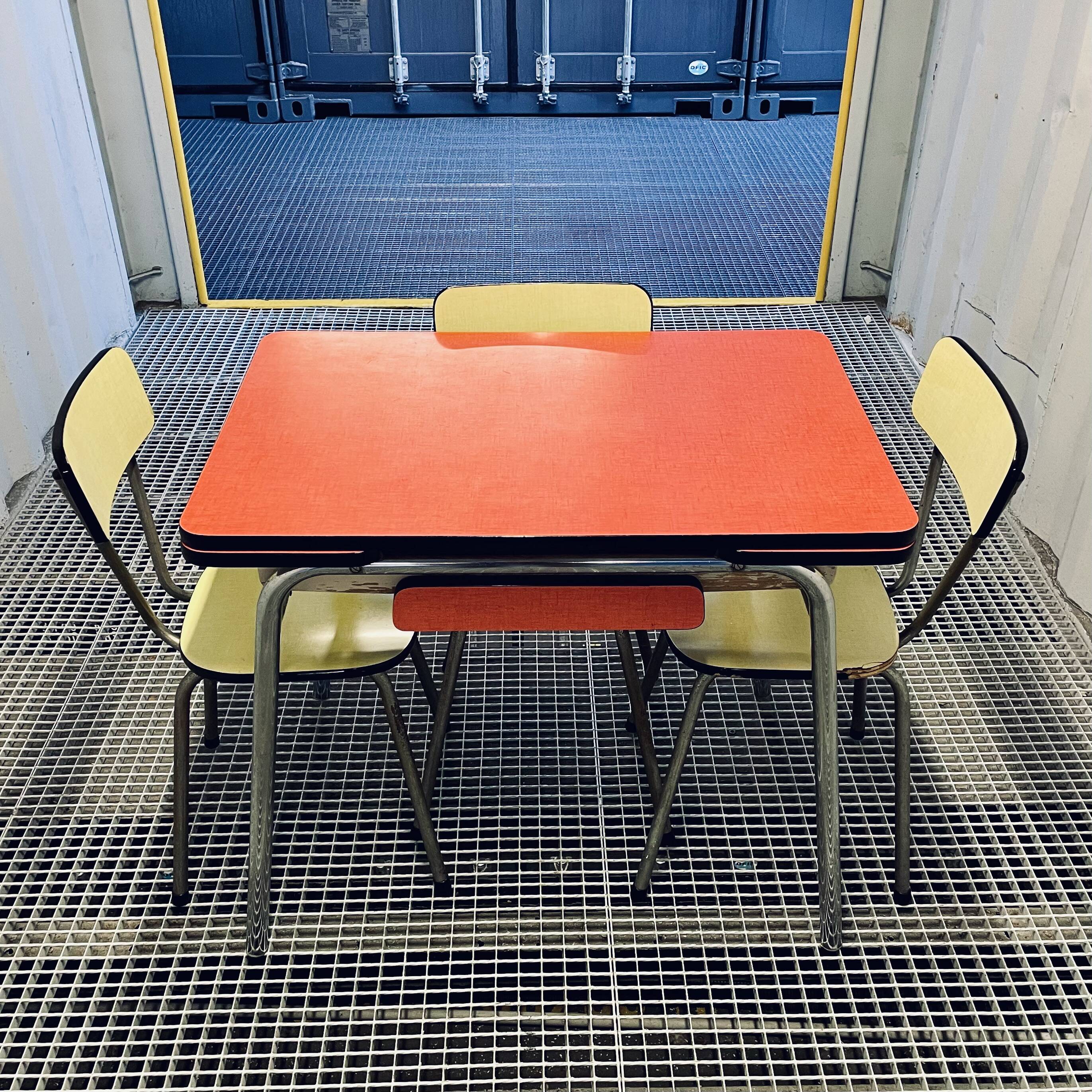Red Formica table and vintage yellow chairs