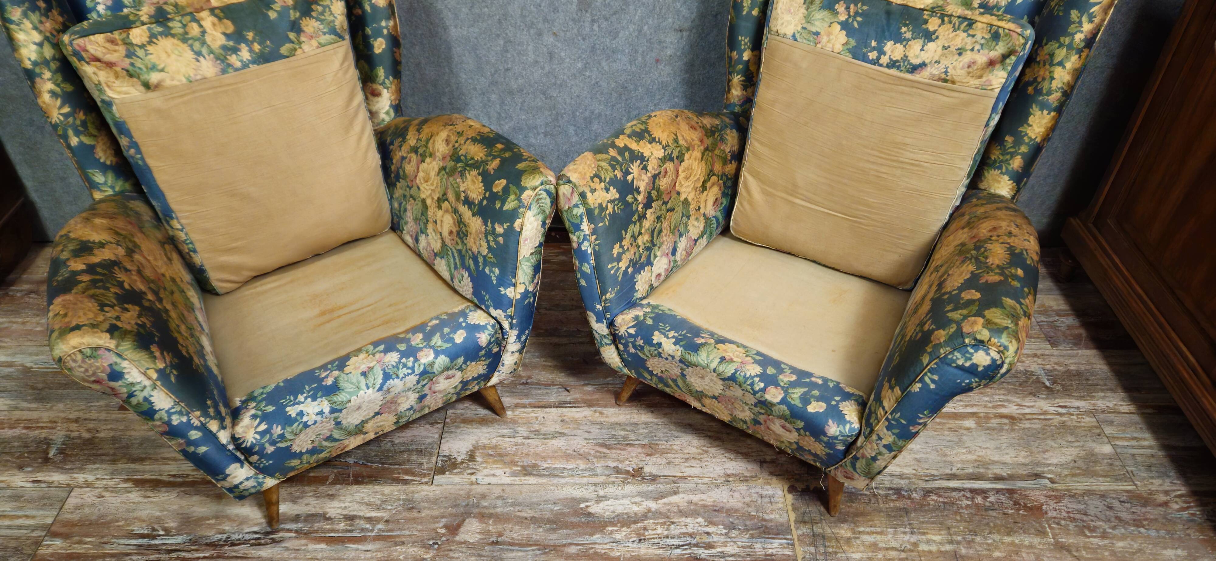 Pair of vintage armchairs with enveloping backrest.