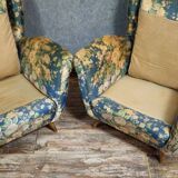 Pair of vintage armchairs with enveloping backrest.
