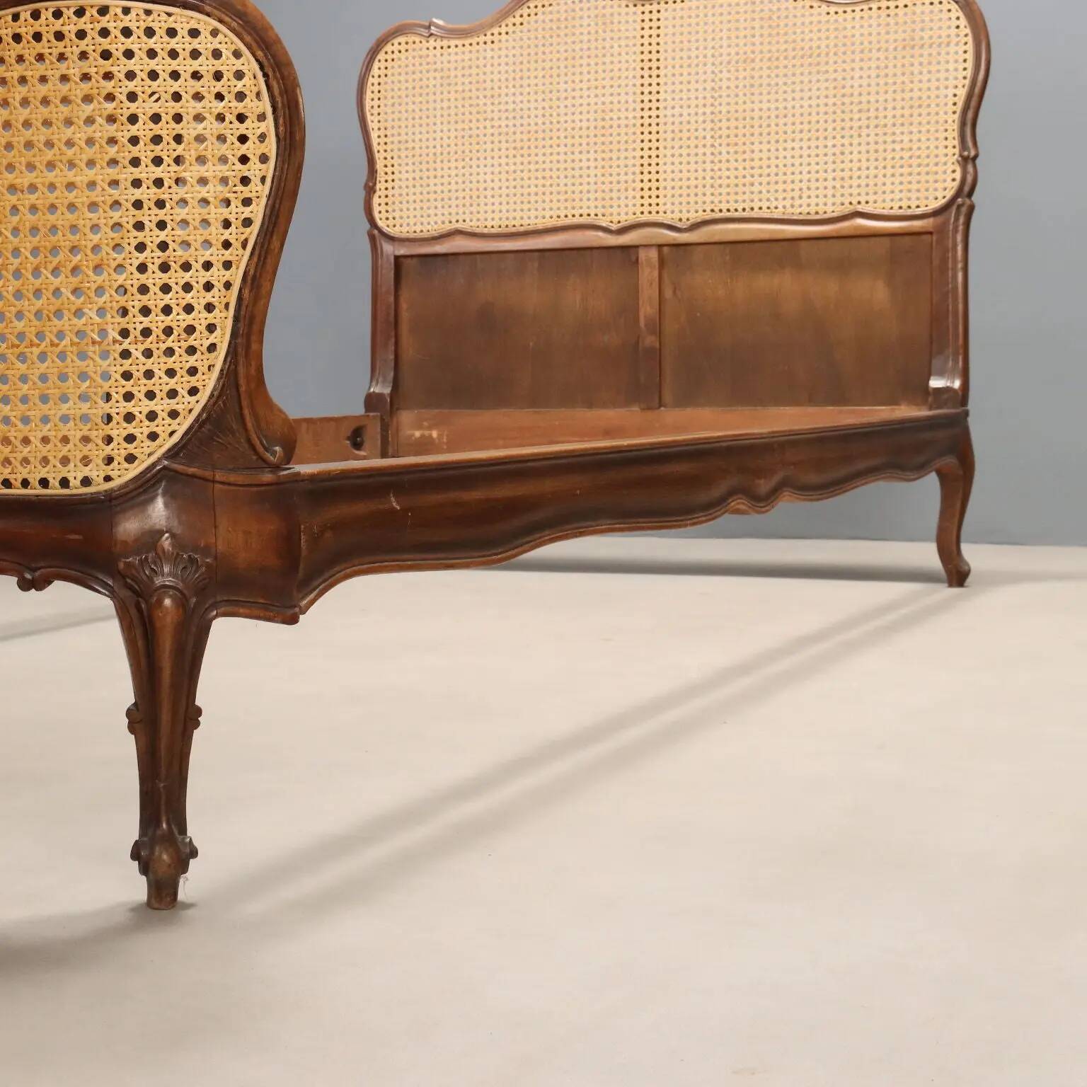 Simple bed in Barocchetto style in walnut.