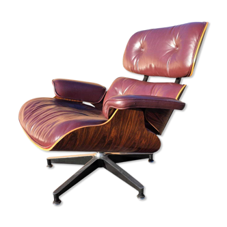 Original Eames lounge chair by Herman Miller in burgundy rosewood.
