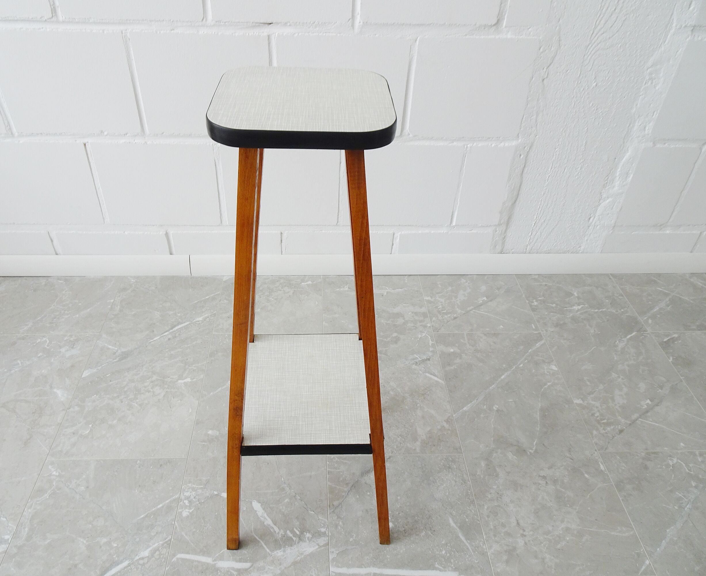 Plant stand made of wood and formica with two shelves, flower column