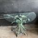 Vintage console in patinated metal with reed leaves.