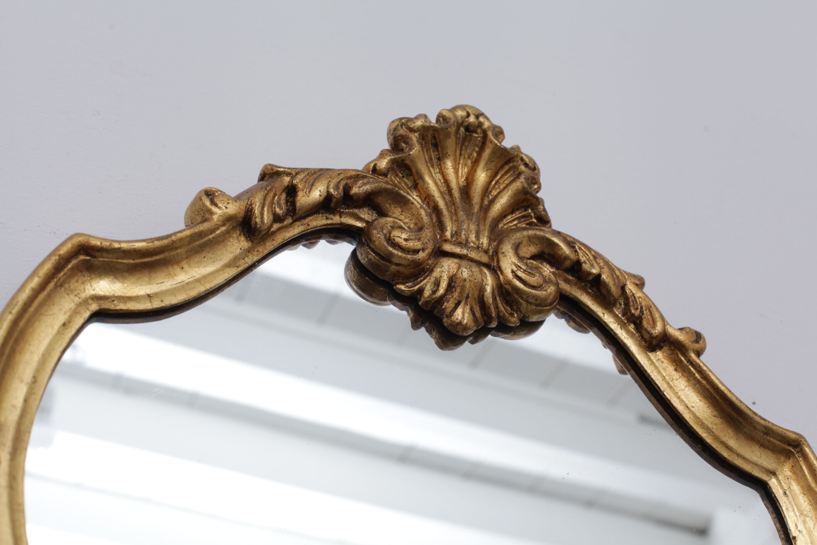 Golden rococo mirror with gold leaf