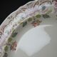 Antique Longchamp service shallow dish with polychrome daisies, ironstone, 19th century.