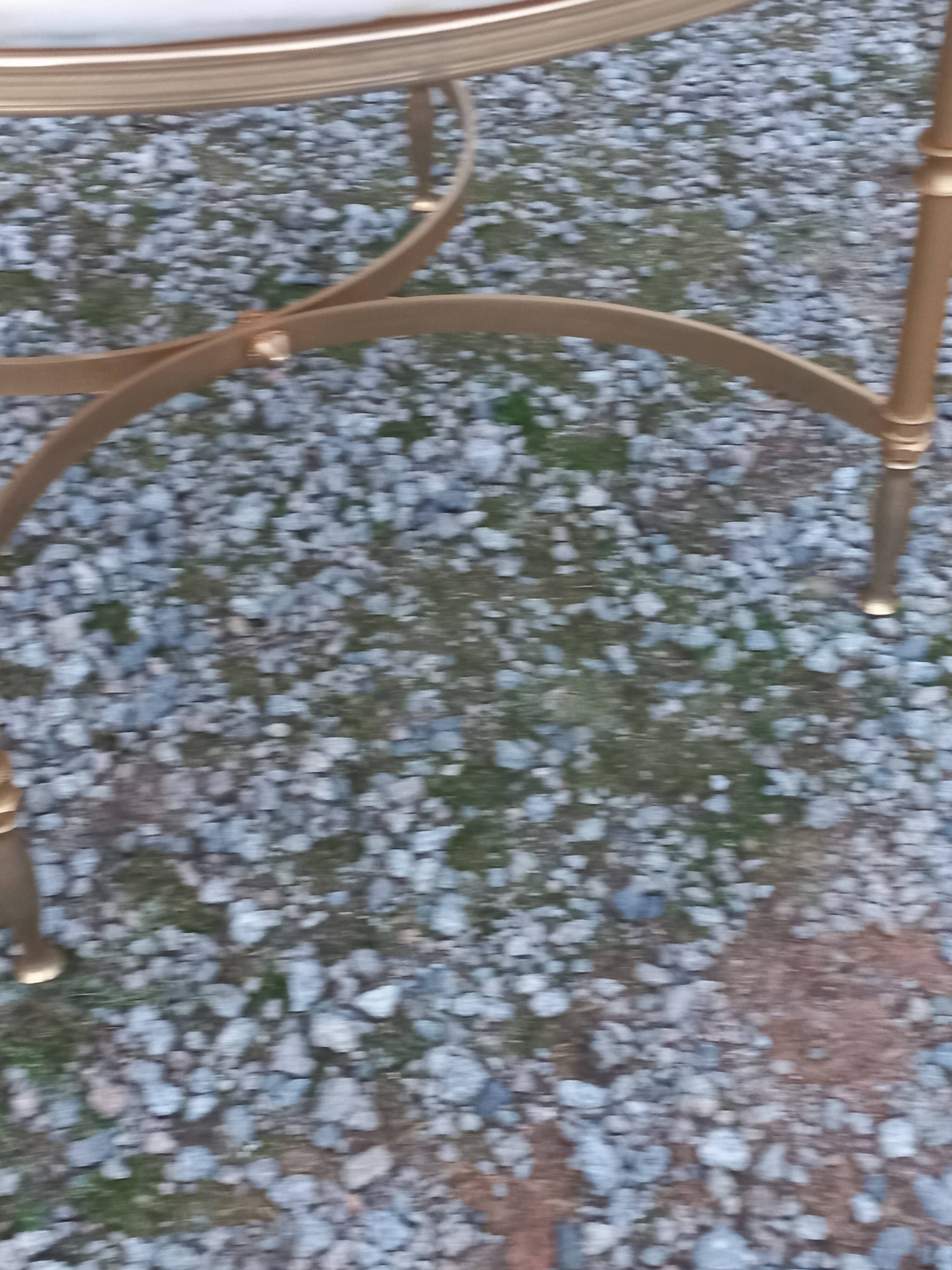 Round neoclassical coffee table with a marble top and golden metal base.