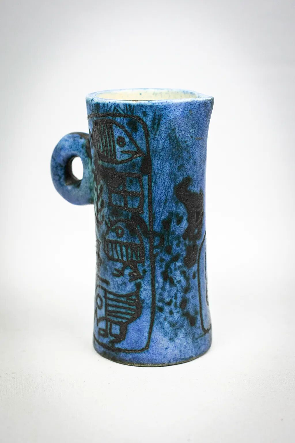 Small jug by Jacques Blin in blue ceramic with engraved animal decoration.