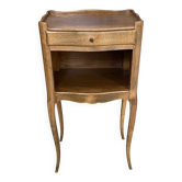 A bedside table with a drawer and a niche in Louis XV style.