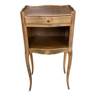 A bedside table with a drawer and a niche in Louis XV style.