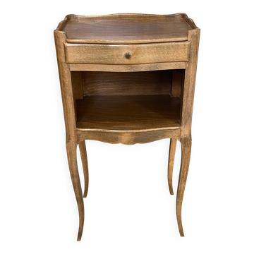 A bedside table with a drawer and a niche in Louis XV style.