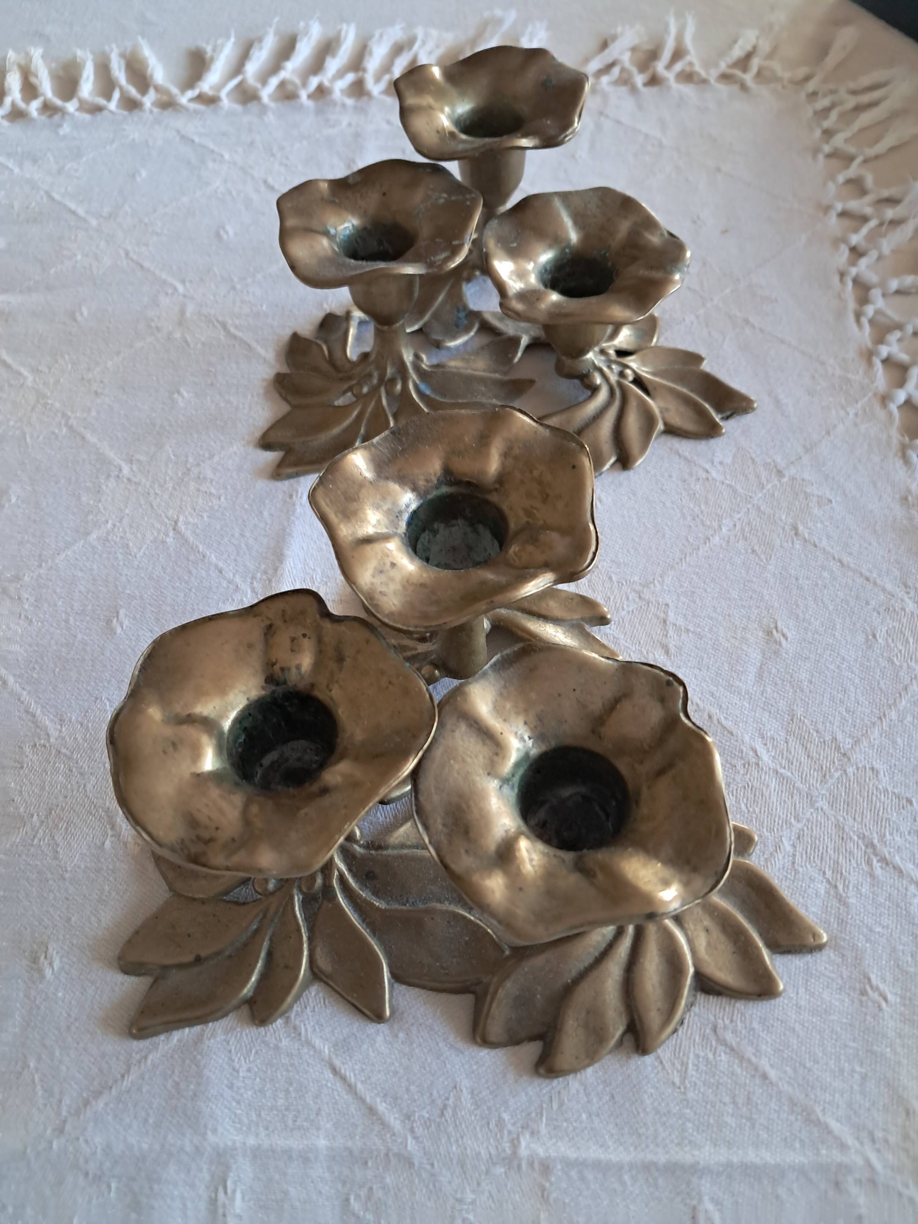 Pair of antique three-branch candlesticks with a floral design.