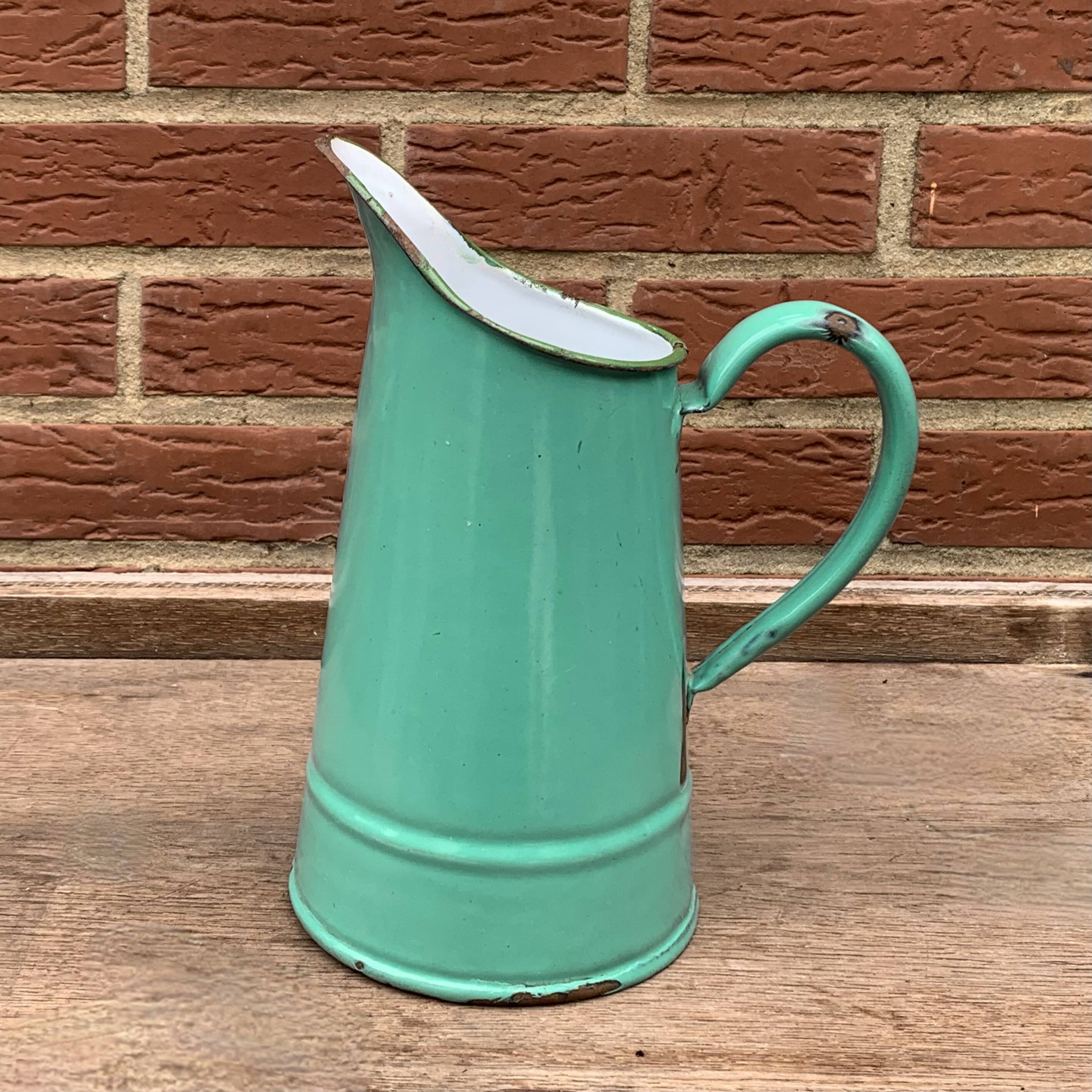 Vintage pitcher in green enameled sheet metal