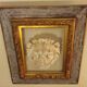 Antique gilded frame with stone lion head ornament on plexiglass
