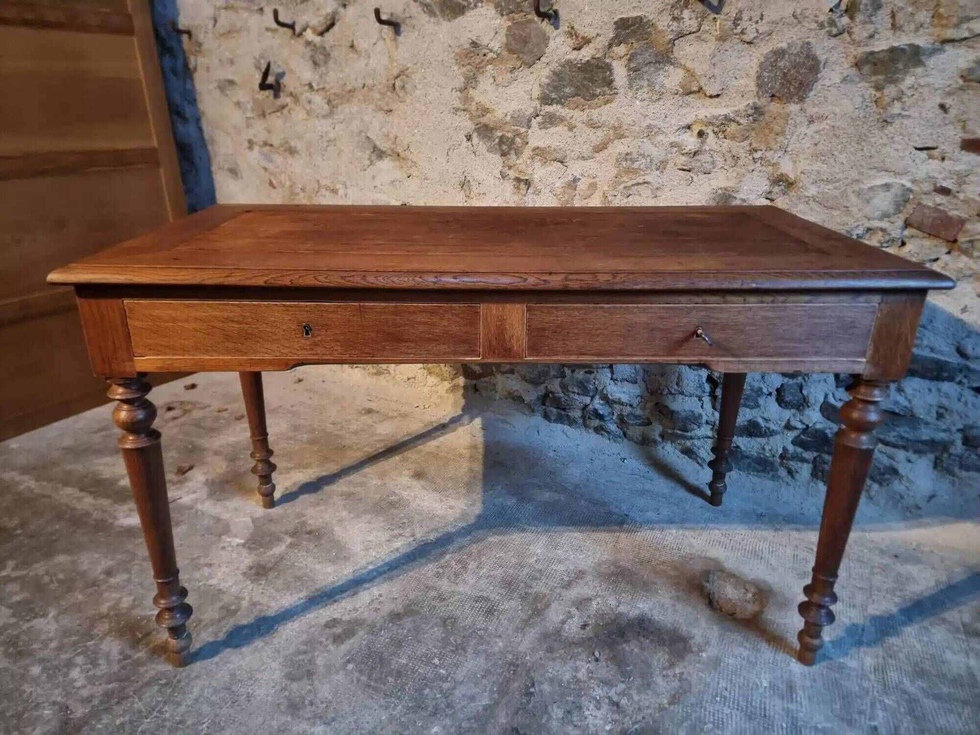 Antique French writing desk in oak with two drawers, 1920s.
