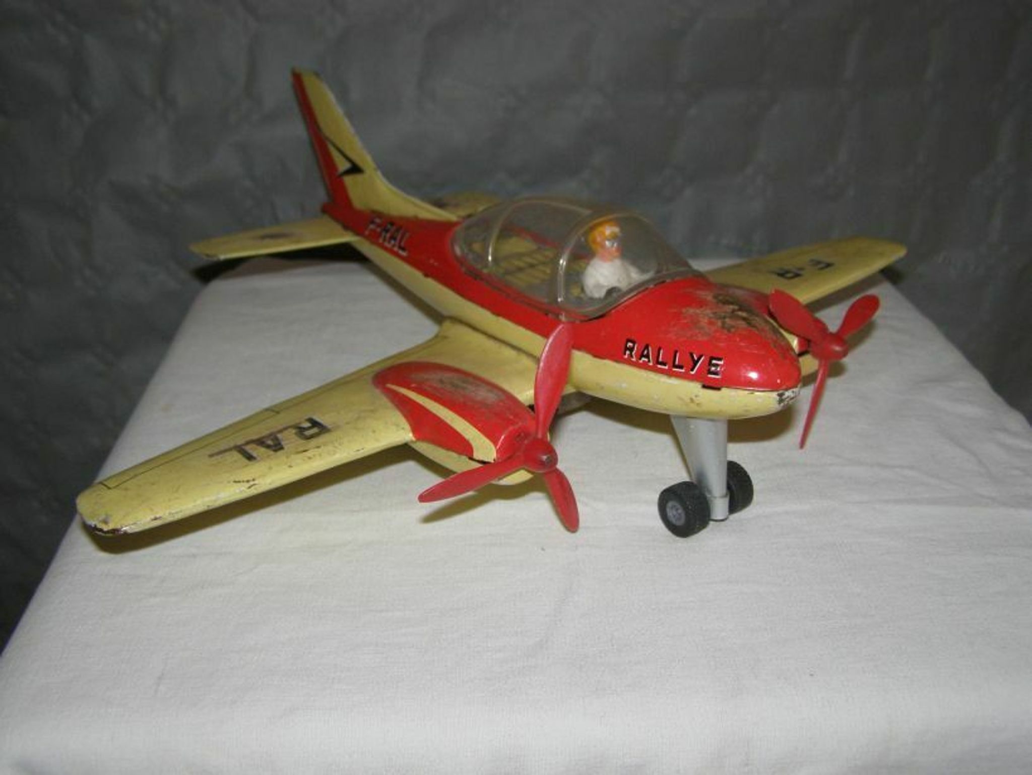 Old metal Joustra toy; propeller aircraft with its pilot friction mechanism