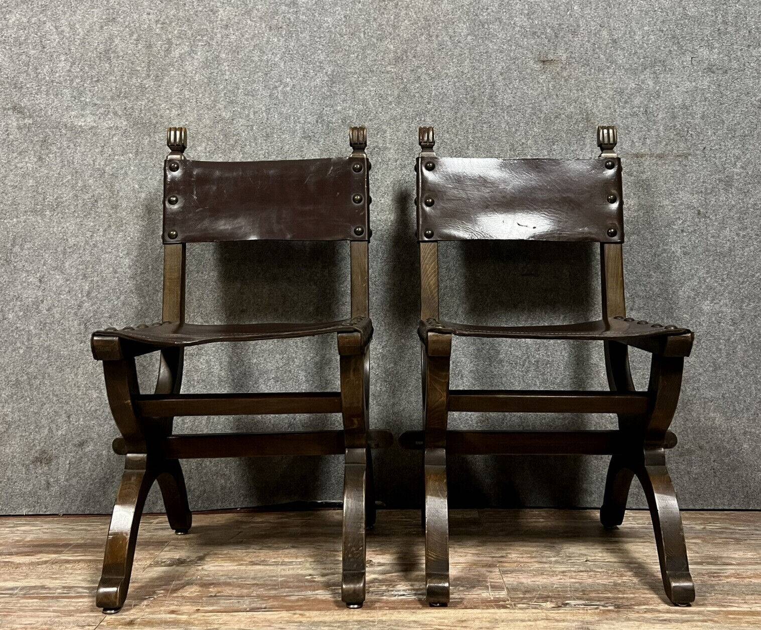 Pair of medieval style chairs in solid wood and leather, 19th century, circa 1850
