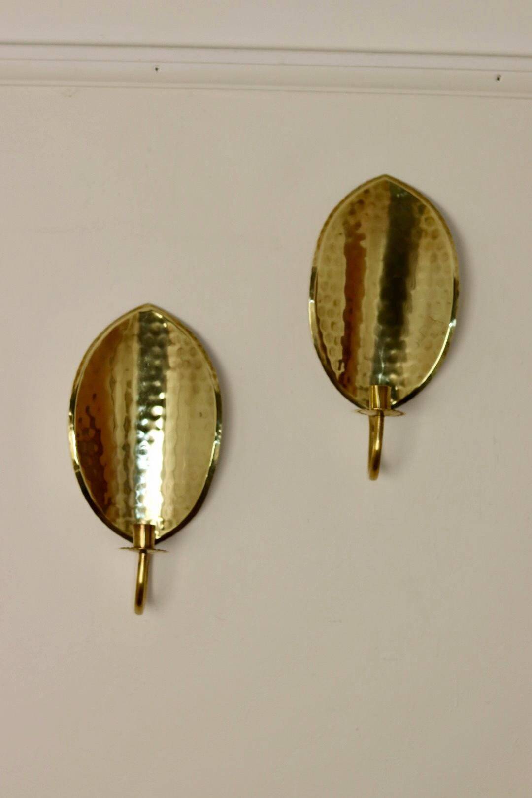 A pair of mid-century Swedish brass wall lights.